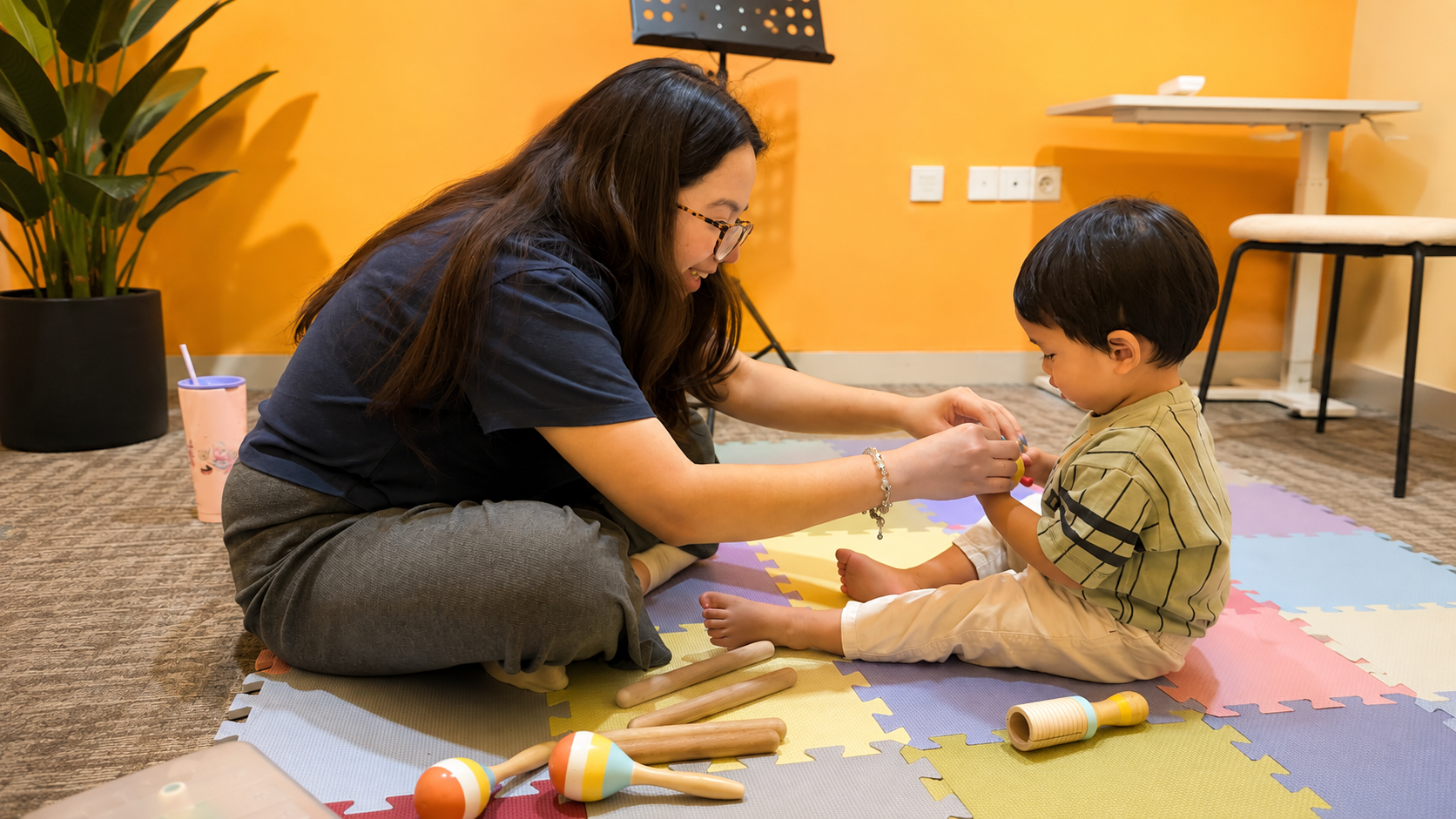 Parent, toddler, and teacher interacting during a Music Adventure lesson