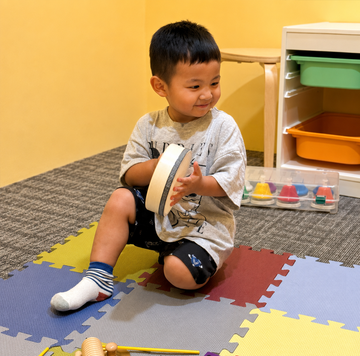 Toddler building musical skills through hands-on activities